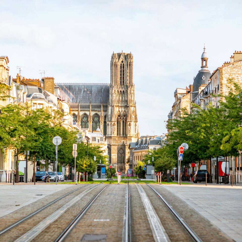 Street view with famous cathedral in Reims city in Champagne-Ardenne region, France